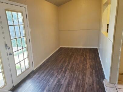 6123 35th Street Lubbock, TX 79407 - Photo 5 of 7 an empty room with wooden floor and windows