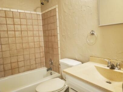6123 35th Street Lubbock, TX 79407 - Photo 6 of 7 a bathroom with a sink toilet and shower