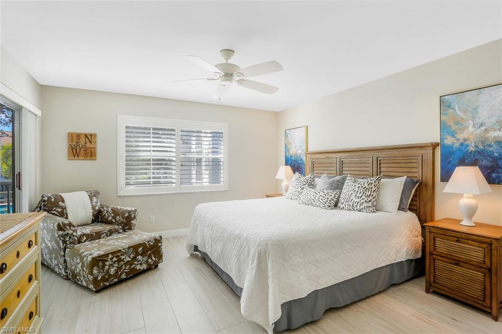 480 Bermuda Cove Way, Unit 1205 Naples, FL 34110 - Photo 18 of 33 a bedroom with a bed and a couch