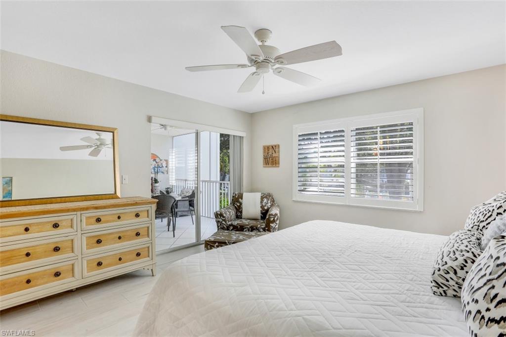 480 Bermuda Cove Way, Unit 1205 Naples, FL 34110 - Photo 19 of 33 a bedroom with a bed a dresser and a window