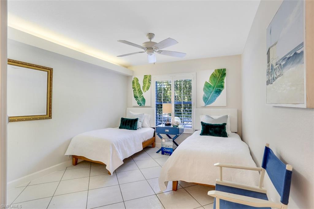 480 Bermuda Cove Way, Unit 1205 Naples, FL 34110 - Photo 21 of 33 a bedroom with a bed and window