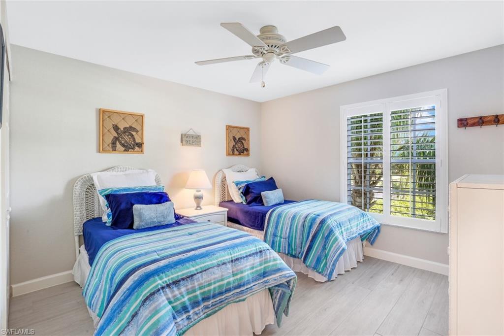 480 Bermuda Cove Way, Unit 1205 Naples, FL 34110 - Photo 23 of 33 a bedroom with two beds and a large window