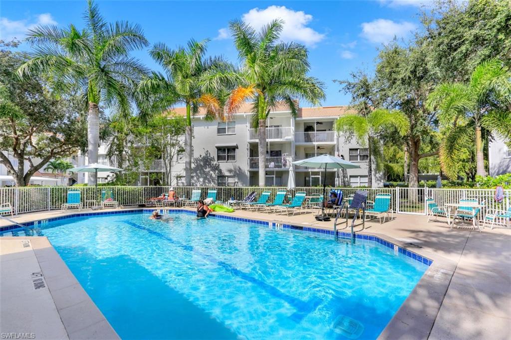 480 Bermuda Cove Way, Unit 1205 Naples, FL 34110 - Photo 27 of 33 a front view of a house with swimming pool and sitting area