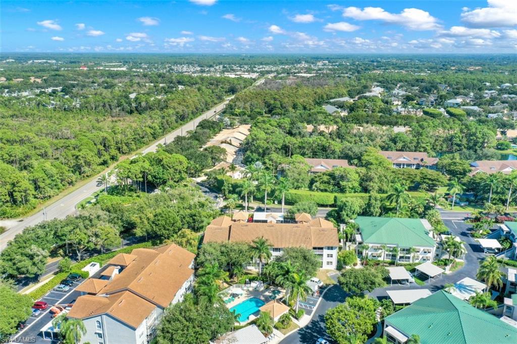 480 Bermuda Cove Way, Unit 1205 Naples, FL 34110 - Photo 28 of 33 an aerial view of residential houses with outdoor space and street view