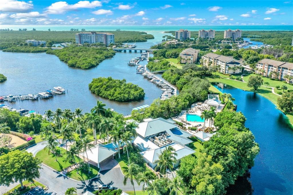 480 Bermuda Cove Way, Unit 1205 Naples, FL 34110 - Photo 31 of 33 an aerial view of a house with a yard and lake view