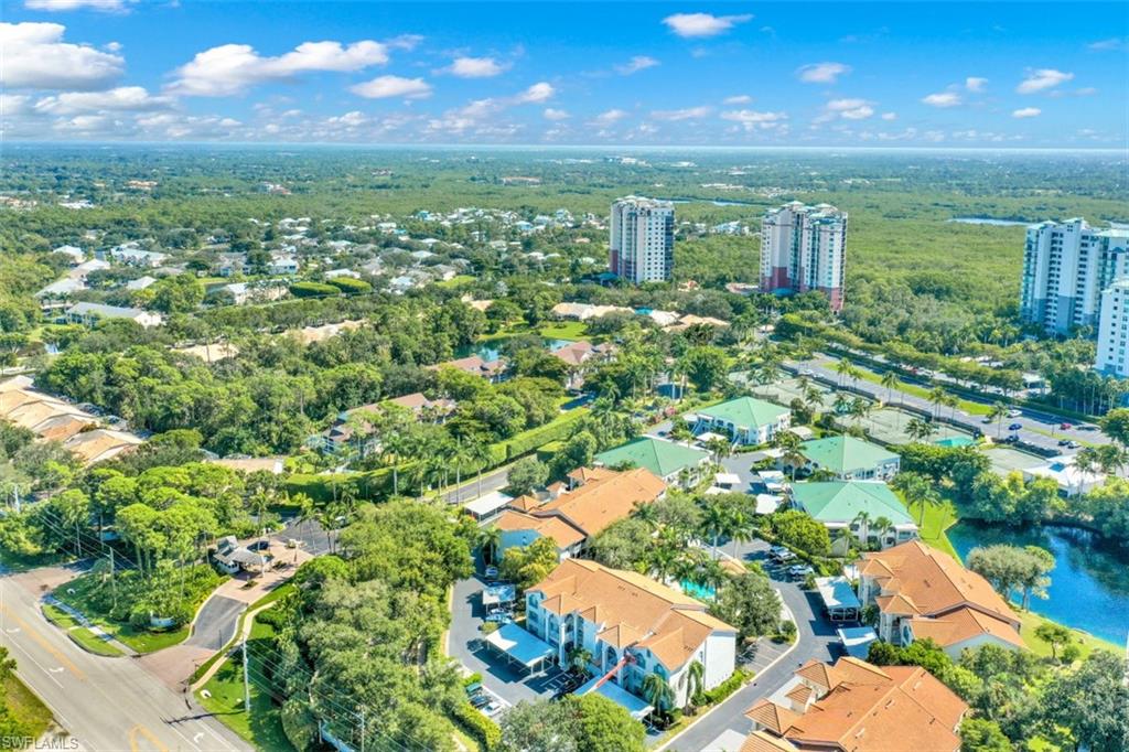 480 Bermuda Cove Way, Unit 1205 Naples, FL 34110 - Photo 4 of 33 an aerial view of residential houses with outdoor space and trees