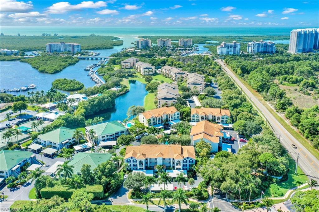 480 Bermuda Cove Way, Unit 1205 Naples, FL 34110 - Photo 5 of 33 an aerial view of residential houses with outdoor space and street view