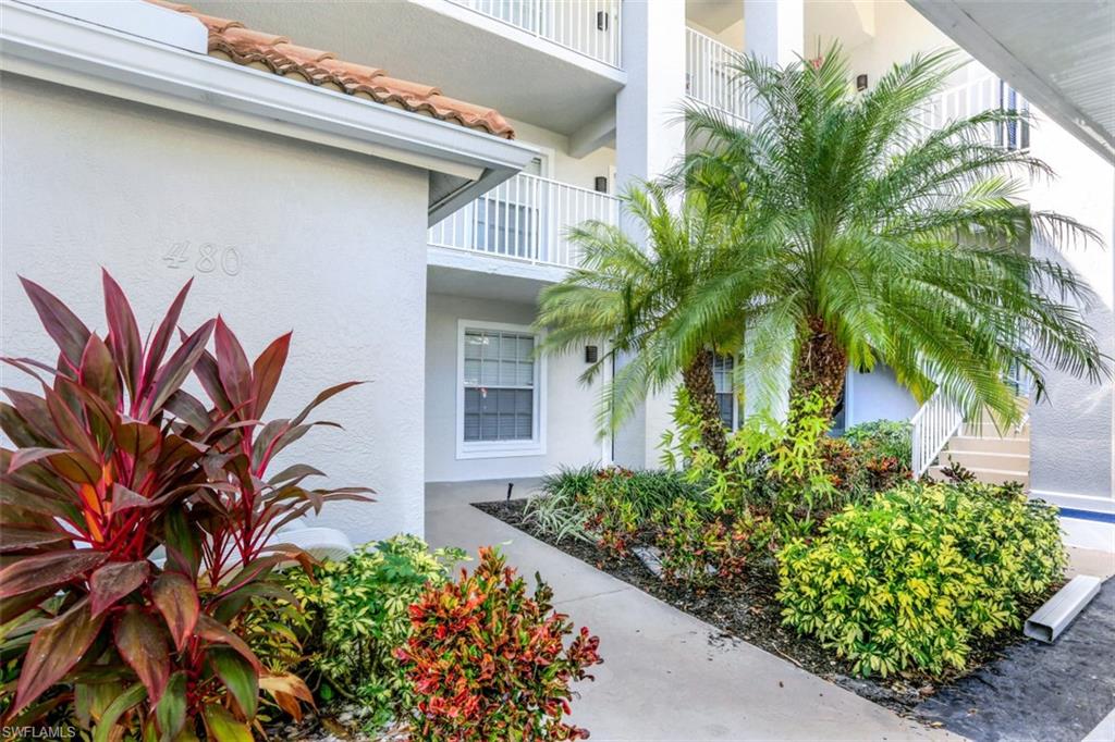 480 Bermuda Cove Way, Unit 1205 Naples, FL 34110 - Photo 6 of 33 a front view of a house with a plant