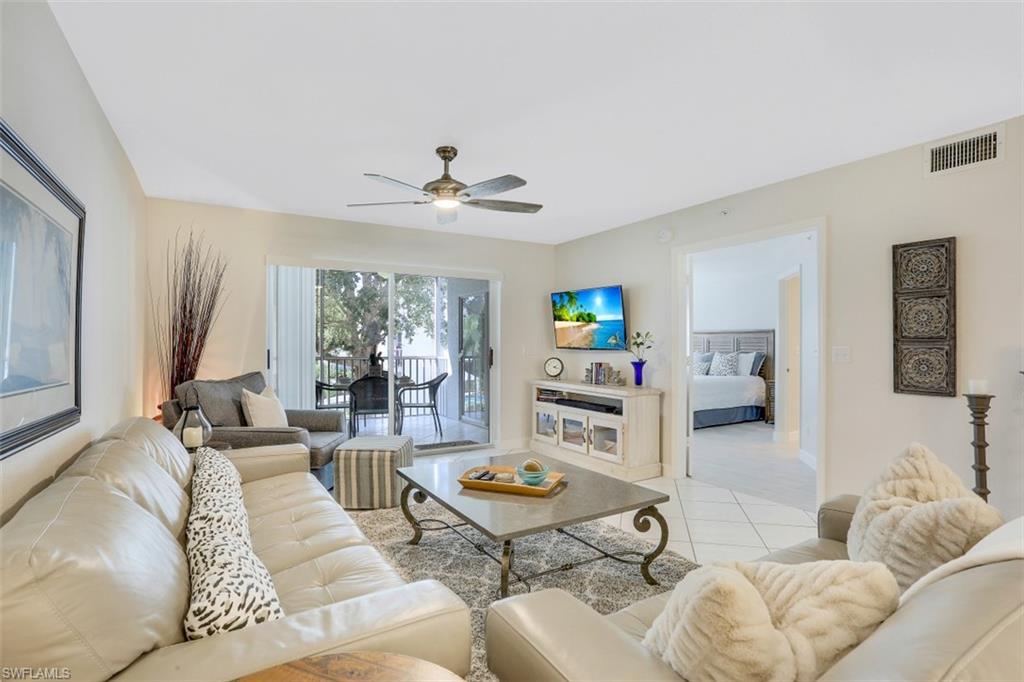 480 Bermuda Cove Way, Unit 1205 Naples, FL 34110 - Photo 8 of 33 a living room with furniture and a large window