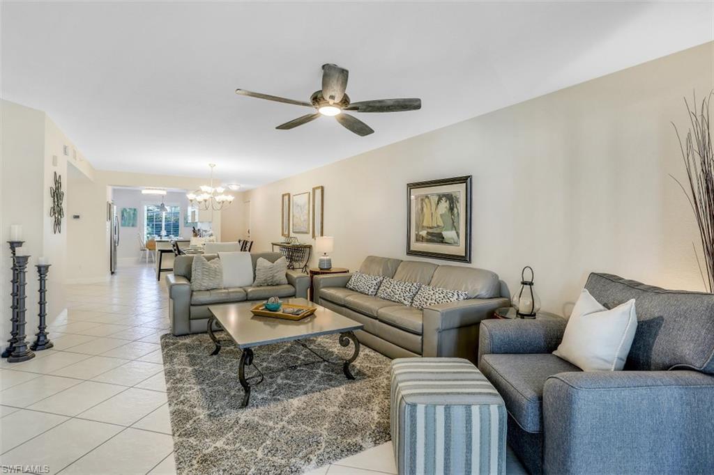 480 Bermuda Cove Way, Unit 1205 Naples, FL 34110 - Photo 9 of 33 a living room with furniture and a wooden floor