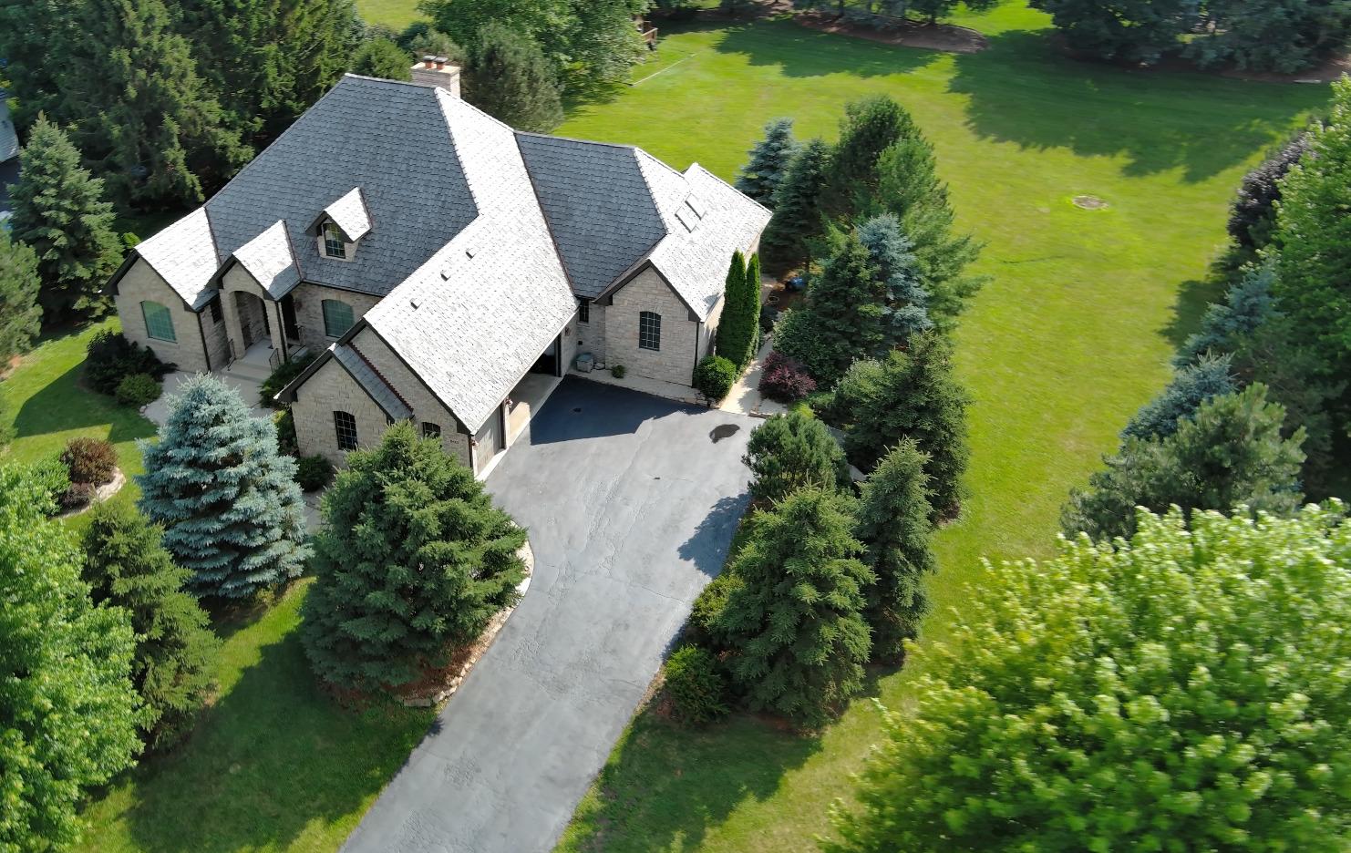 8407 Appaloosa Lane Spring Grove, IL 60081 - Photo 2 of 6 an aerial view of a house with garden space and lake view