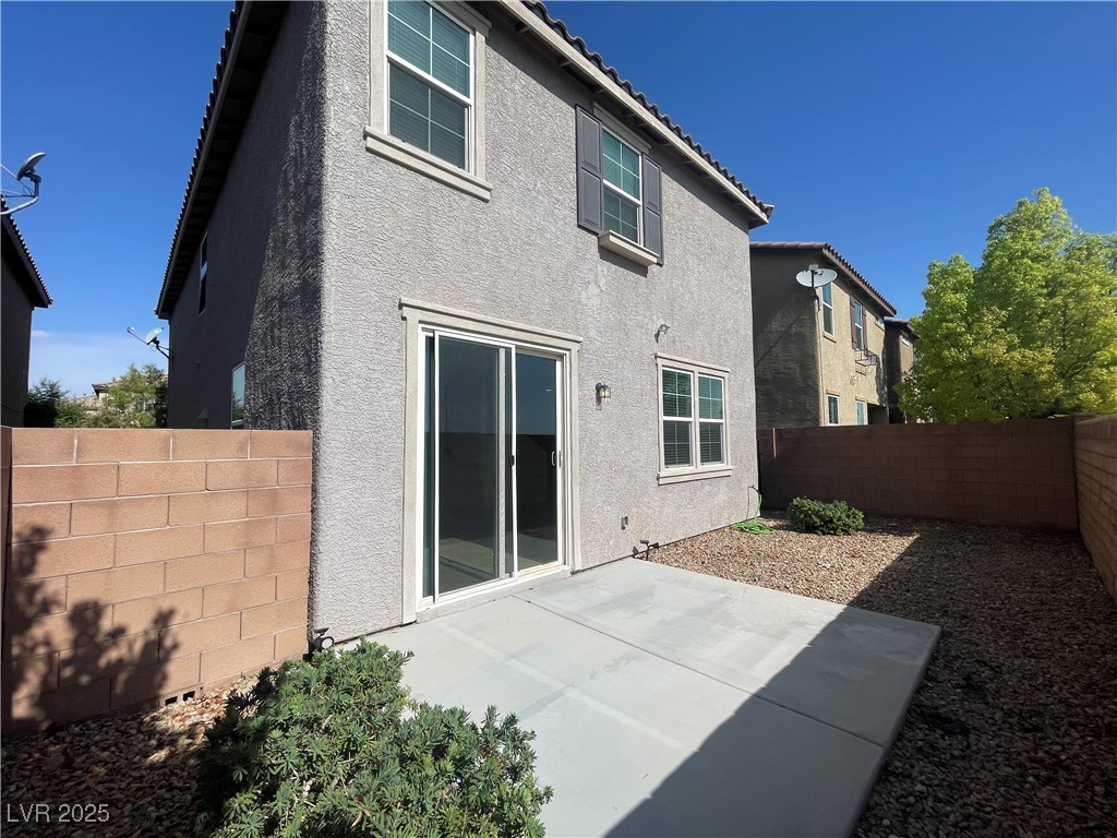 10632 Summerbell Street Las Vegas, NV 89179 - Photo 14 of 16 Back of house with stucco siding, a fenced backyard, and a patio area