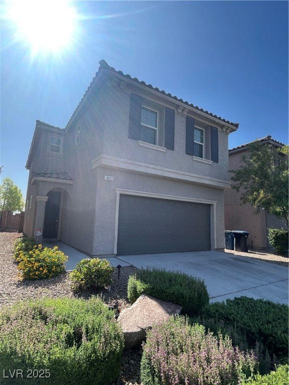 10632 Summerbell Street Las Vegas, NV 89179 - Photo 2 of 16 Traditional-style house featuring an attached garage, stucco siding, and concrete driveway