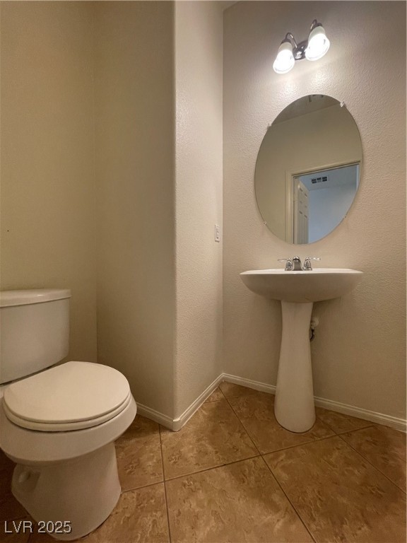 10632 Summerbell Street Las Vegas, NV 89179 - Photo 3 of 16 Half bathroom featuring tile patterned flooring and toilet