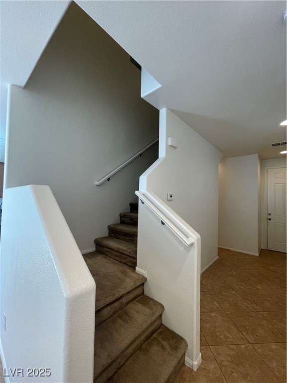 10632 Summerbell Street Las Vegas, NV 89179 - Photo 5 of 16 Staircase with baseboards and tile patterned flooring