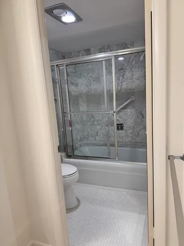 a bathroom with a shower and a toilet