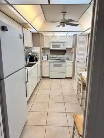 a kitchen with stainless steel appliances a refrigerator sink and microwave