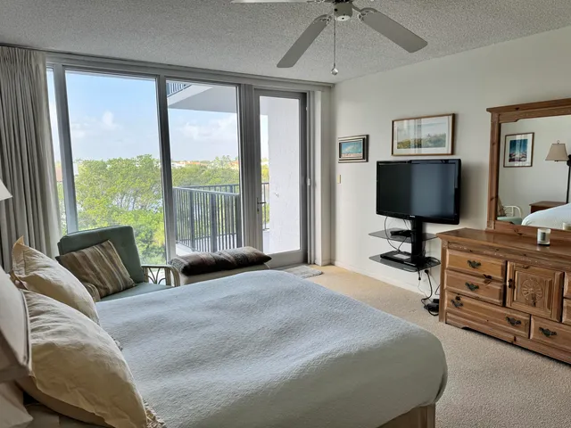 a bedroom with a bed and flat screen tv