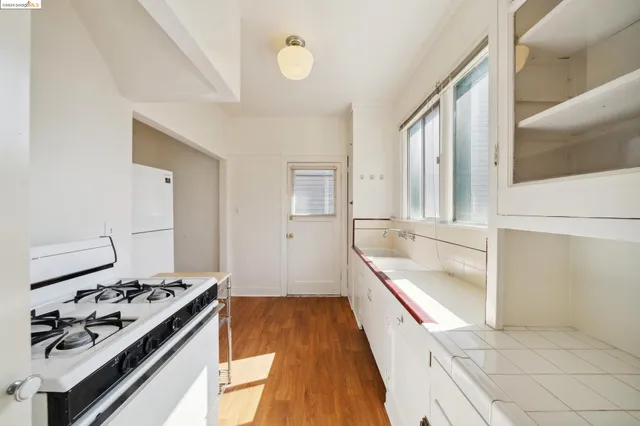 a kitchen with granite countertop a refrigerator and a stove