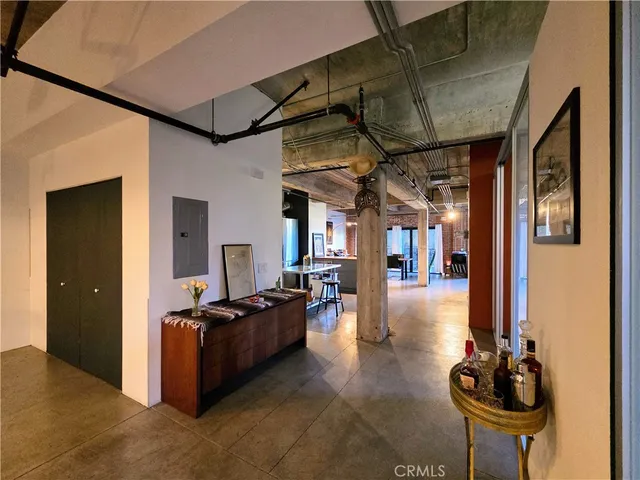 a view of a hallway with chairs and a potted plant