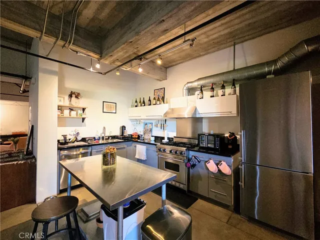 a kitchen with granite countertop stainless steel appliances and wooden cabinets