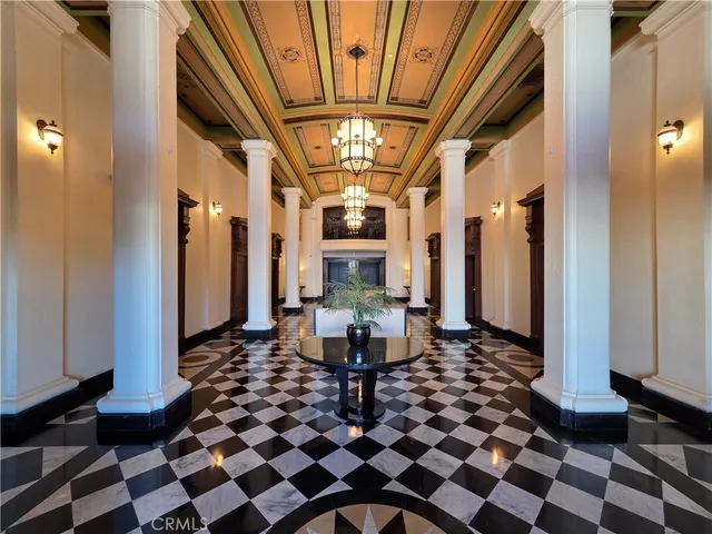a living room with a black white checkered floor with a dining table and chairs