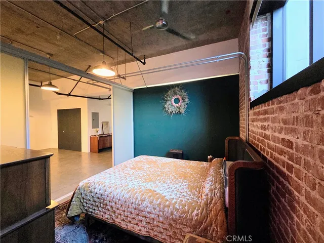 a bedroom with a bed and a bookshelf