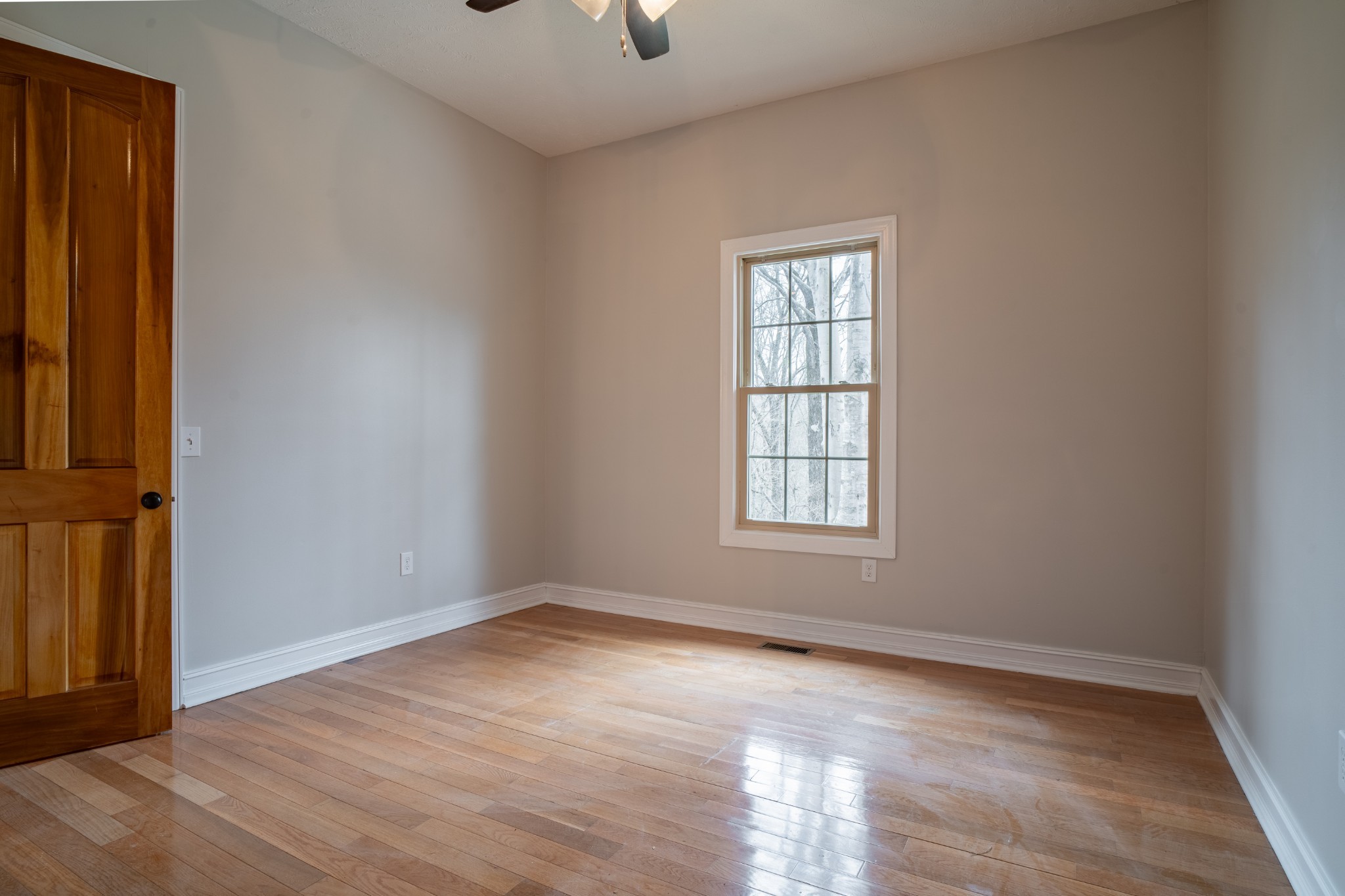 550 Laurel Crown Road Manchester, TN 37355 - Photo 68 of 87 a view of an empty room with wooden floor and a window