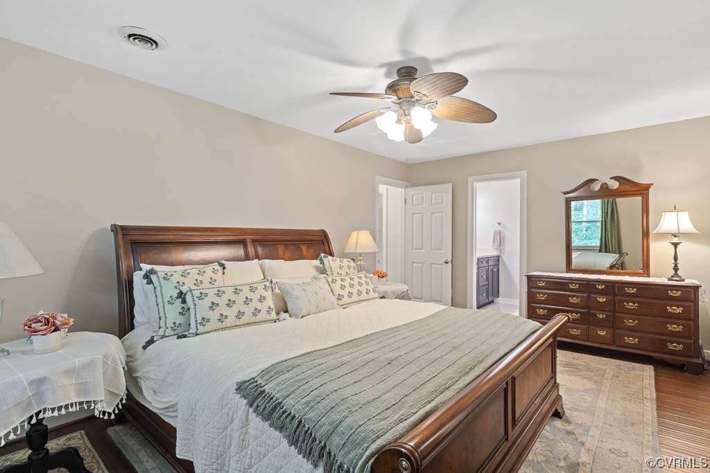 14704 Acorn Ridge Place Midlothian, VA 23112 - Photo 10 of 17 a bedroom with a large bed and a chandelier