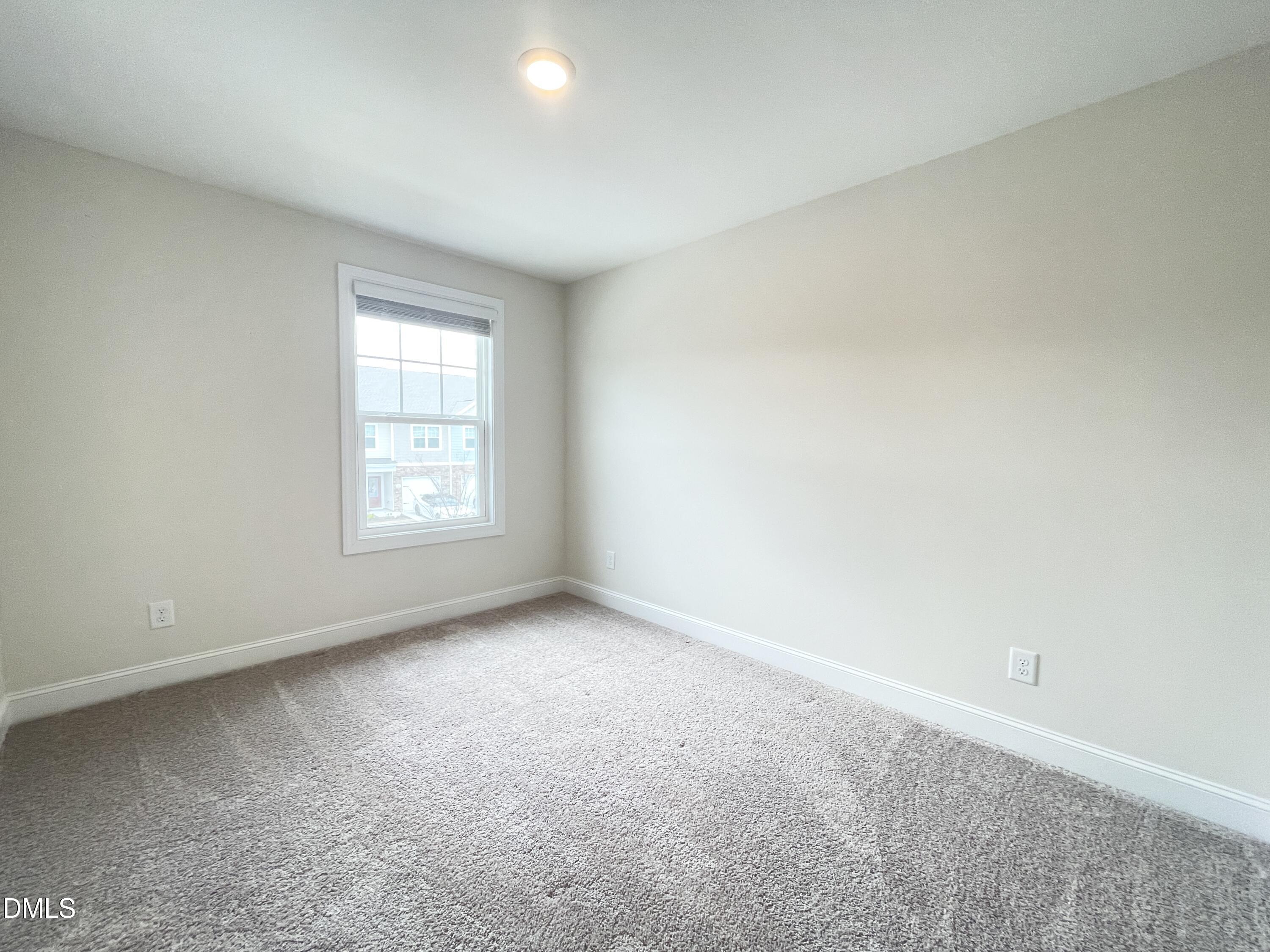 6911 Outfall Point Lane Raleigh, NC 27616 - Photo 23 of 34 an empty room with windows