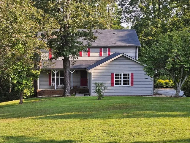 a front view of house with yard and green space