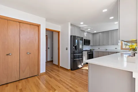a kitchen with stainless steel appliances a refrigerator and a stove top oven