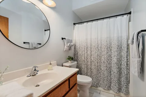 a bathroom with a sink toilet and a mirror