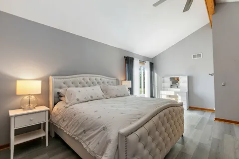 a bedroom with a bed and a lamp