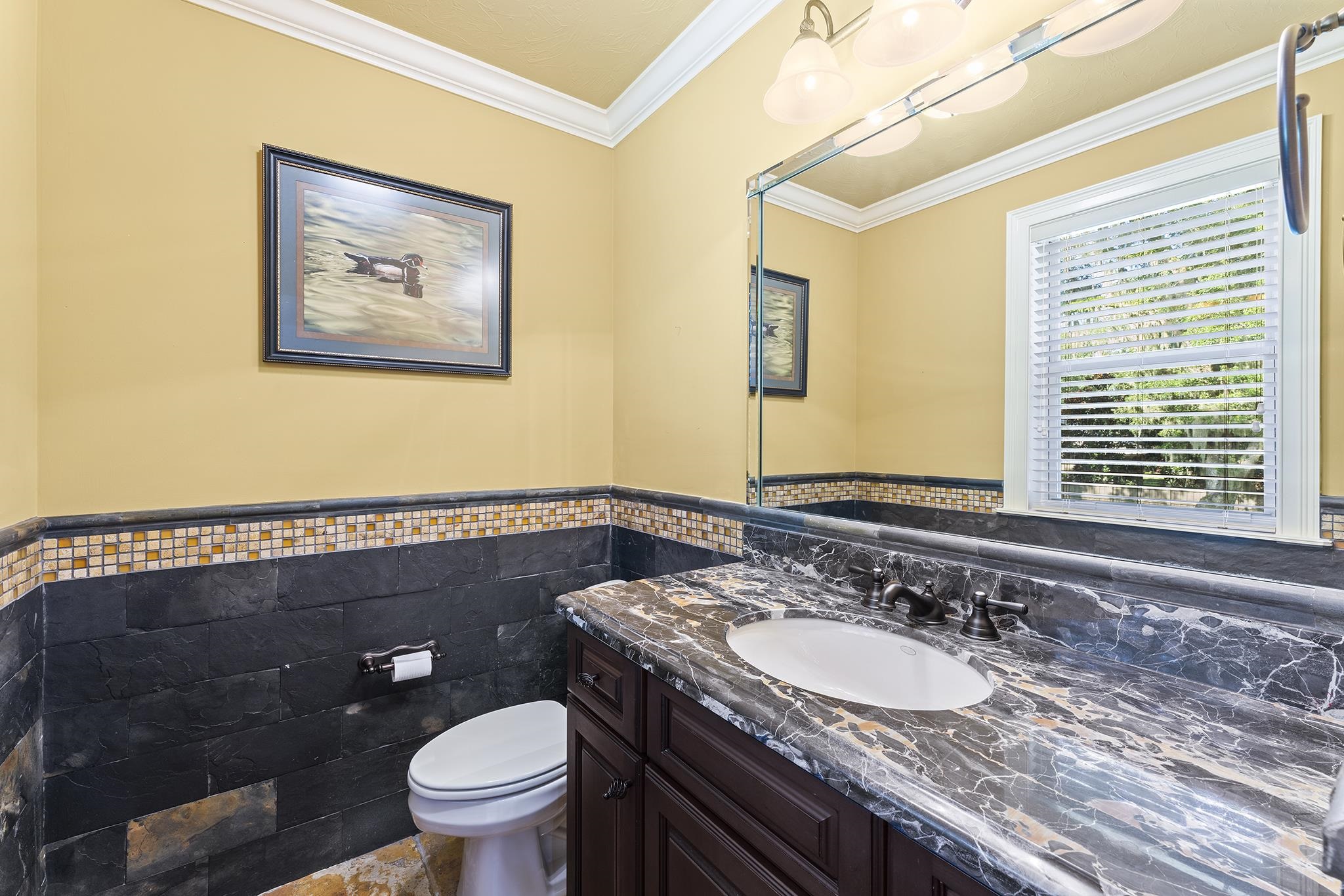 8289 Colee Cove Road St. Augustine, FL 32092 - Photo 47 of 50 a bathroom with a granite countertop toilet a sink and a large mirror