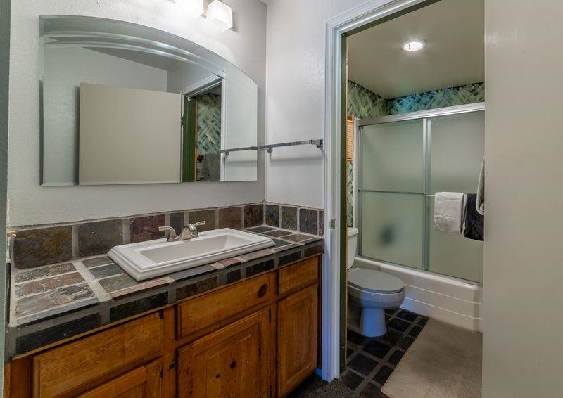 3253 Meridian Boulevard, Unit 214 Mammoth Lakes, CA 93546 - Photo 19 of 28 a bathroom with a sink a toilet and mirror