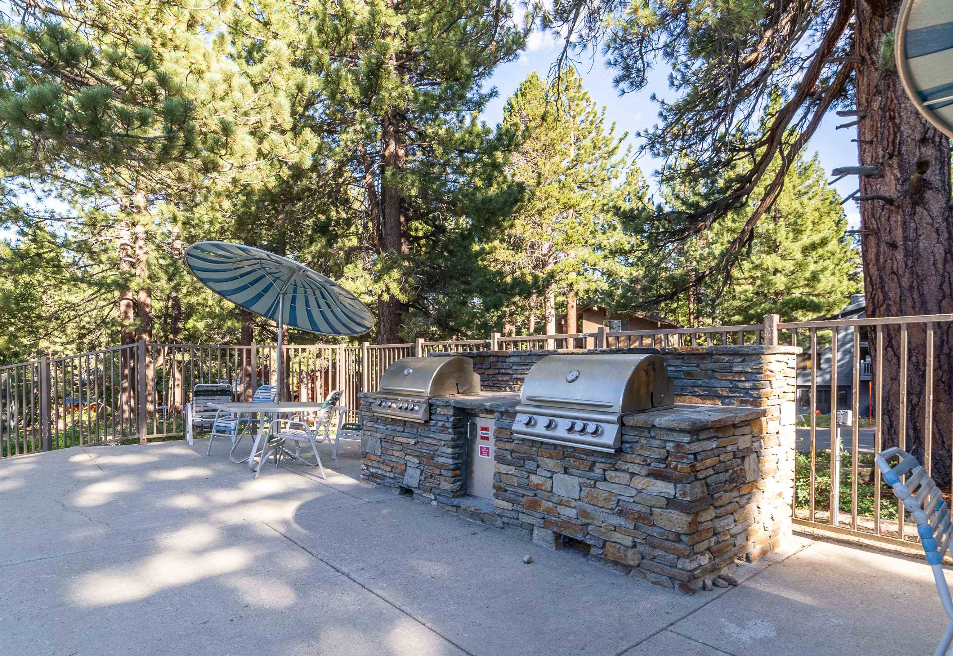 3253 Meridian Boulevard, Unit 214 Mammoth Lakes, CA 93546 - Photo 25 of 28 a view of a wooden bench with chairs in the patio