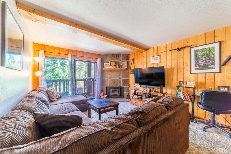 3253 Meridian Boulevard, Unit 214 Mammoth Lakes, CA 93546 - Photo 4 of 28 a living room with furniture and a flat screen tv