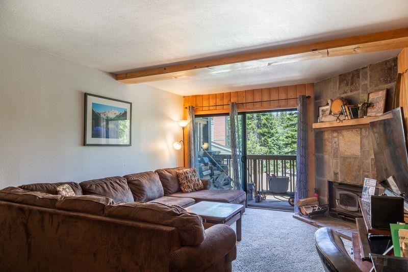 3253 Meridian Boulevard, Unit 214 Mammoth Lakes, CA 93546 - Photo 5 of 28 a living room with furniture a large window and a flat screen tv