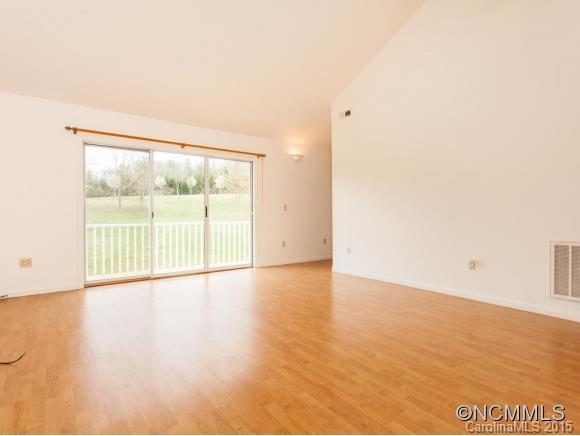 104 Hampton Road Leicester, NC 28748 - Photo 4 of 19 a view of an empty room with wooden floor and a window
