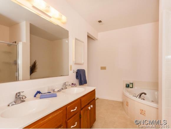 104 Hampton Road Leicester, NC 28748 - Photo 10 of 19 a bathroom with a tub sink and mirror