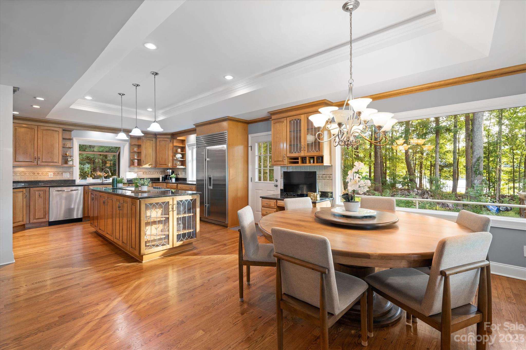 766 Eagle Road Waxhaw, NC 28173 - Photo 17 of 45 a kitchen with stainless steel appliances kitchen island granite countertop a stove a refrigerator a oven a sink with a dining table and chairs