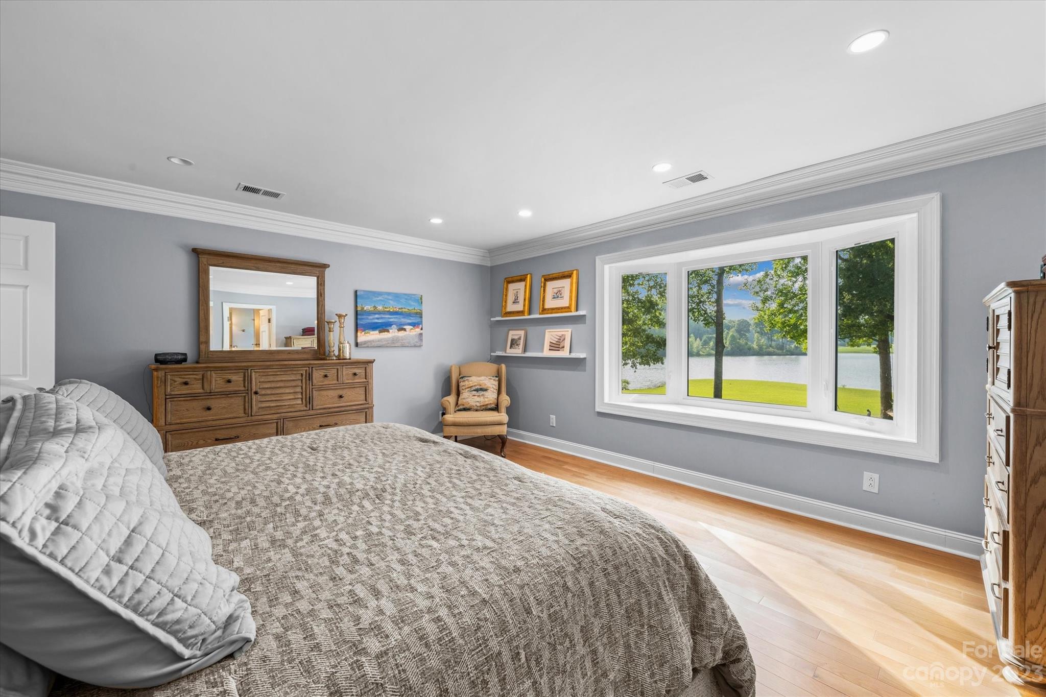 766 Eagle Road Waxhaw, NC 28173 - Photo 22 of 45 a spacious bedroom with a bed and wooden floor