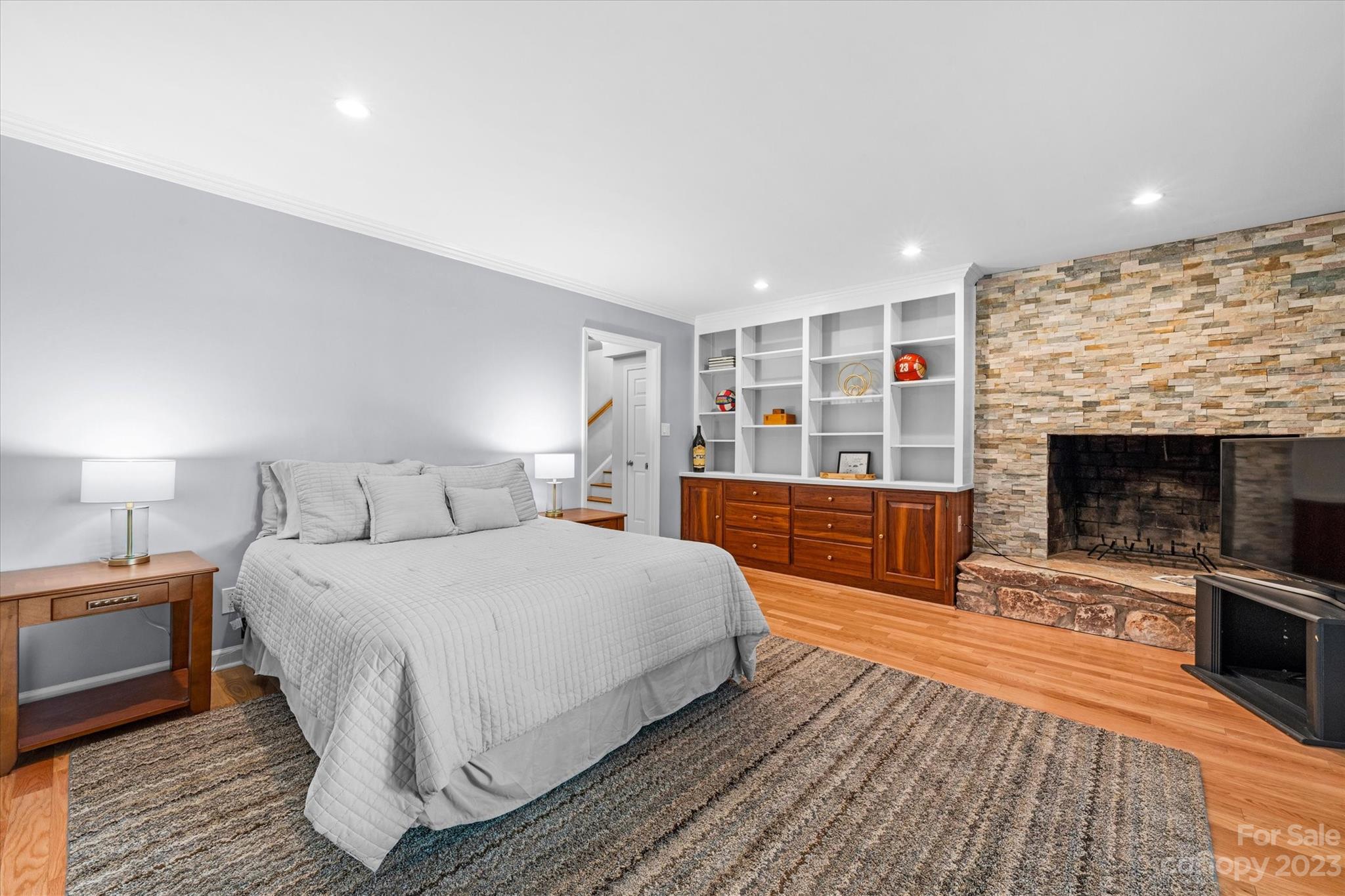 766 Eagle Road Waxhaw, NC 28173 - Photo 29 of 45 a bedroom with a large bed and a fireplace