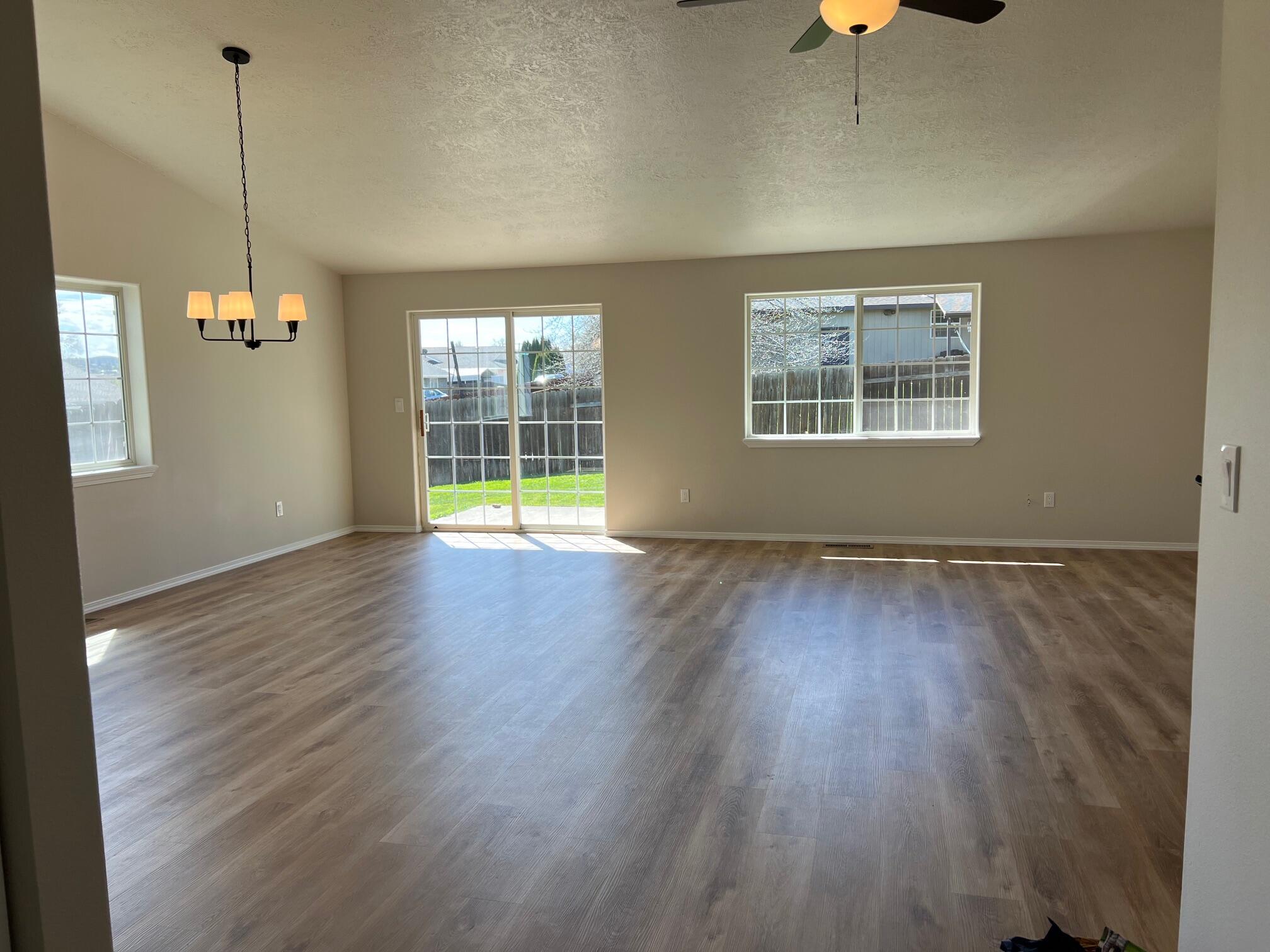 629 Deer Ridge Court Madras, OR 97741 - Photo 14 of 39 a view of an empty room with wooden floor and a window