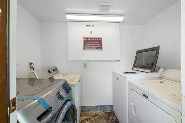 a storage room with a stove and a sink