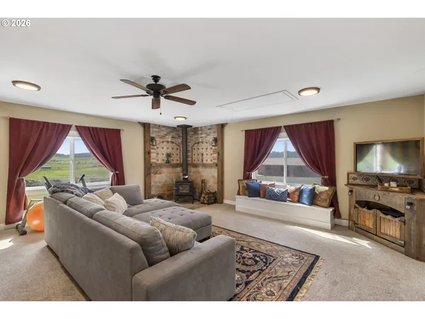a large bedroom with a bed and a large window