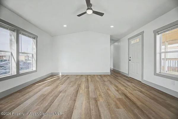 wooden floor in an empty room with a window