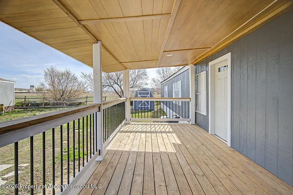 a view of balcony with wooden floor