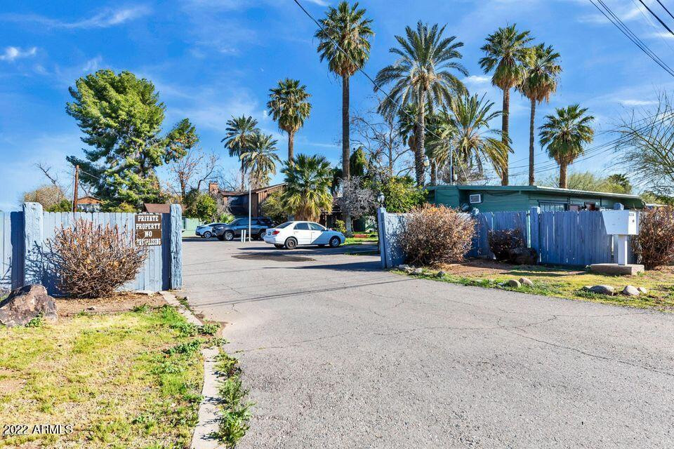 a view of a street with a cars park side of a road